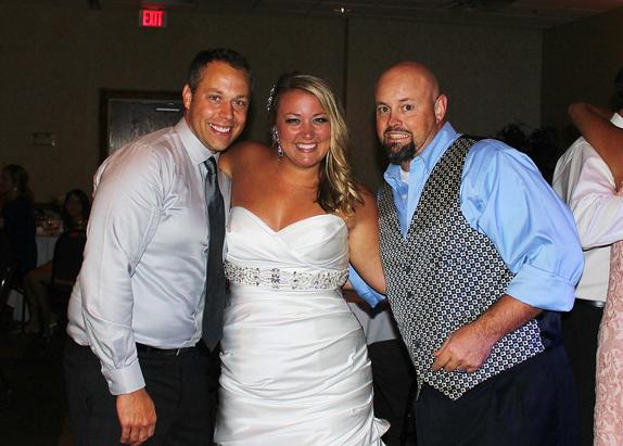 At their Wedding Reception in Eureka Springs at the Inn of the Ozarks, Lance and Kelsey Lukasavitz pose for a party pic with the emcee DJSean Hearn with Music In Motion.