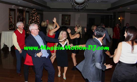 Several partiers dance during the Christmas celebration held by the Fayetteville Country Club.