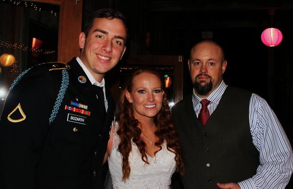DJSean Hearn with Music in Motion steps away from the mixer to take a photo with the bride and groom, Austin & Stephanie Bozarth at their wedding reception in Fayetteville AR at the Garden Room on Dickson Street.