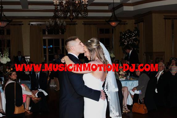 Matt & Kakki Nutter, both in the military in Florida, share a kiss during their first dance at the wedding reception at the Springdale Country Club.