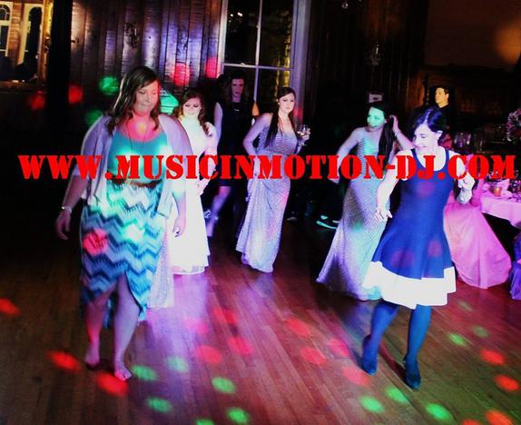 Lots of dancers do the Cha Cha Slide in the Grand Ballroom on a wildly lighted dance floor. The reception was held at the Crescent Hotel in Eureka Springs AR for D and Katherine Saune.