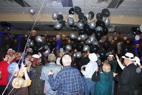The black and silver balloons drop at the stroke of midnight at the New Year's Eve Party at the the Best Western Inn of the Ozarks in Eureka Springs AR.
