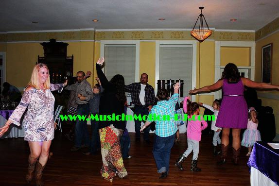 Several guests at the Charlie and Robin Witt Wedding reception in Eureka Springs at the Basin Park Hotel show off the dance moves to the Chicken Dance.