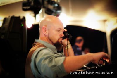 Excellent picture of Entertainer Sean Hearn in Fayetteville, Arkansas taken by Kim Lowery photography depicting in his element, interacting with the crowd, mixing in the perfect song for the situation.